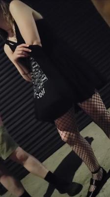 Candid skinny goth girl in fishnets on the street at night