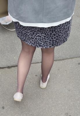 Woman in brown pantyhose and skirt