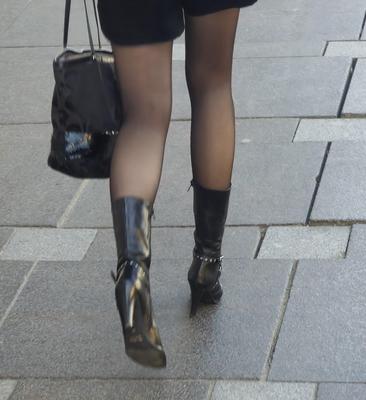 Girl in black pantyhose and leather boots