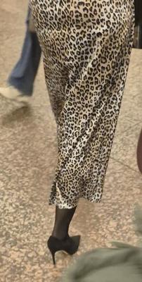Woman in long leopard print skirt