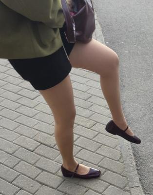 Girl in shorts, nude pantyhose and ballerinas shoes