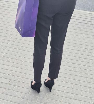 Woman in trousers and suede wedges heels