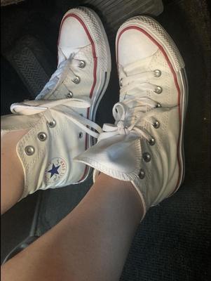 Heather removing her sweaty Converse in the car
