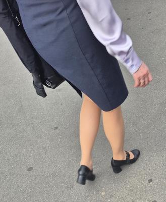Woman in midi skirt and nude pantyhose