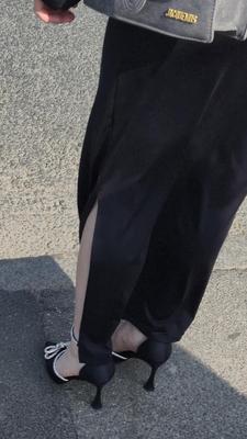 セクシーなサテンのかかとと長いスカートの女性