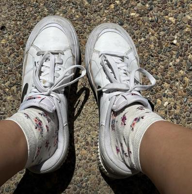 Kristin removes shoes and her sweaty, dirty socks