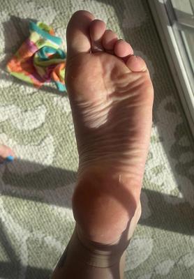 Ash removing socks to show her blue toes and hot soles